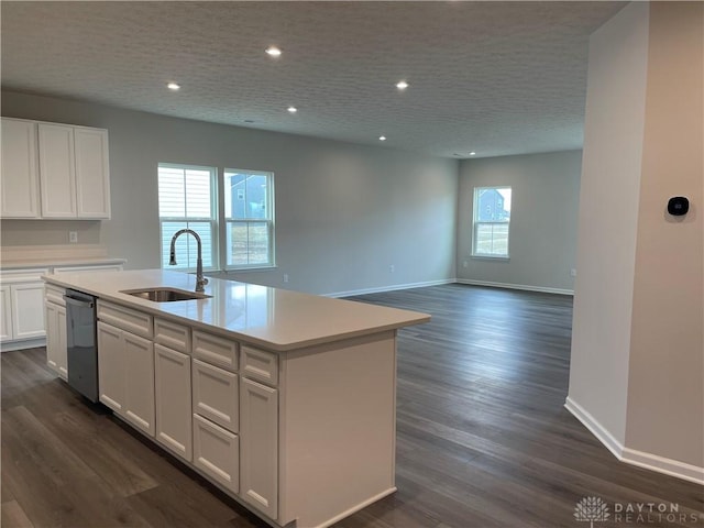 kitchen featuring dishwashing machine, dark wood-type flooring, a sink, white cabinetry, and light countertops