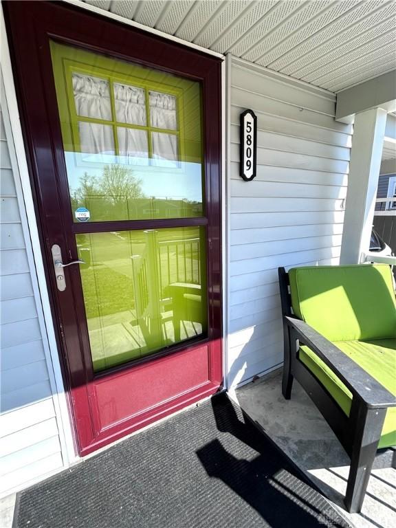 entrance to property featuring covered porch