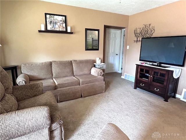 carpeted living area featuring visible vents, baseboards, and a textured ceiling