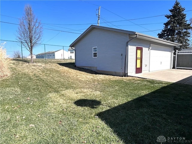 view of property exterior with fence, concrete driveway, and a yard