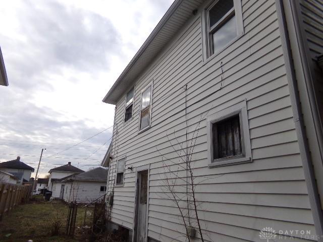 view of side of property featuring fence