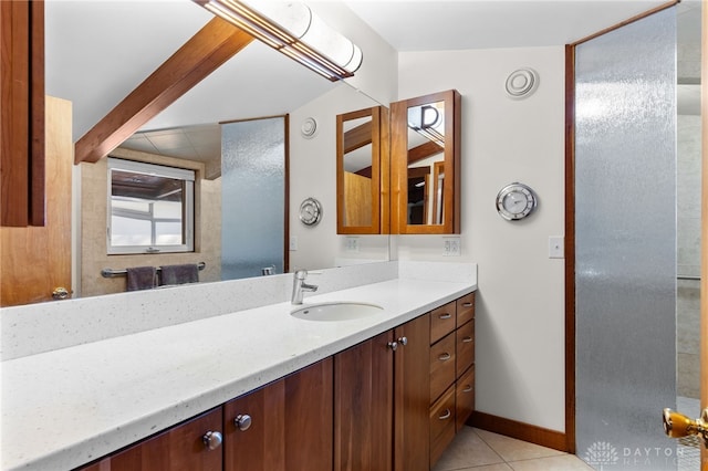 bathroom featuring vanity, baseboards, and tile patterned floors