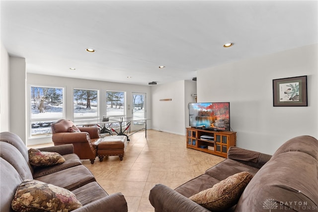 living room featuring light tile patterned floors, baseboards, and recessed lighting