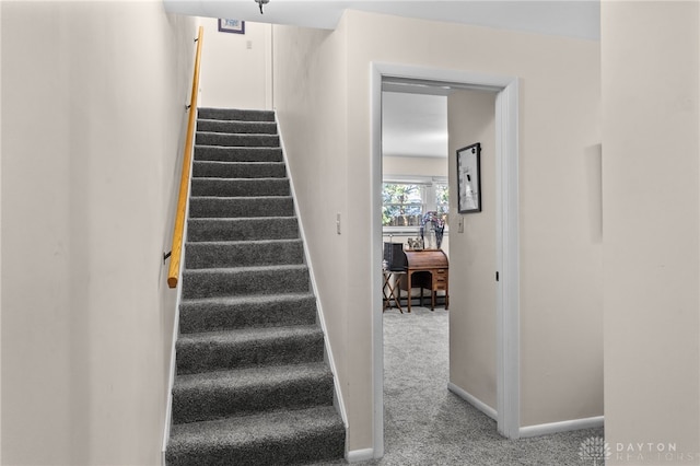 staircase with carpet floors and baseboards