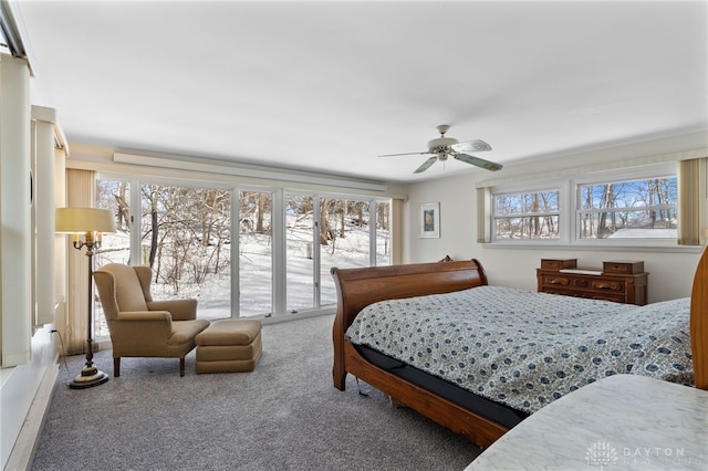 carpeted bedroom featuring ceiling fan and access to exterior