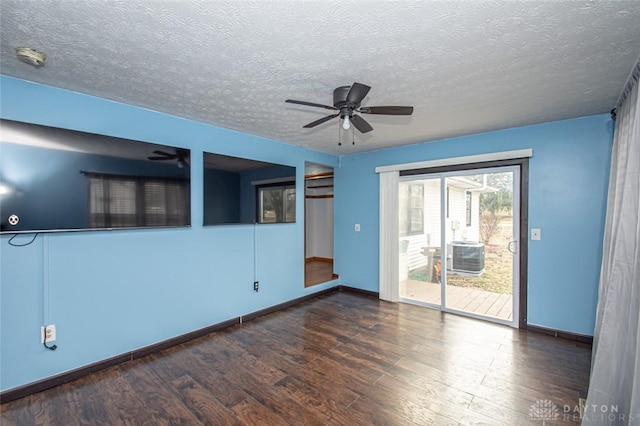 unfurnished room featuring a textured ceiling, wood finished floors, a ceiling fan, and baseboards