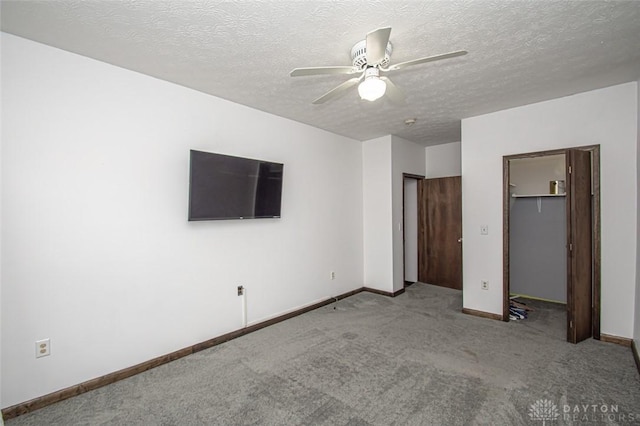 unfurnished bedroom featuring carpet, a closet, baseboards, and a textured ceiling