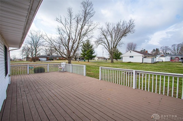 wooden terrace featuring a residential view and a lawn