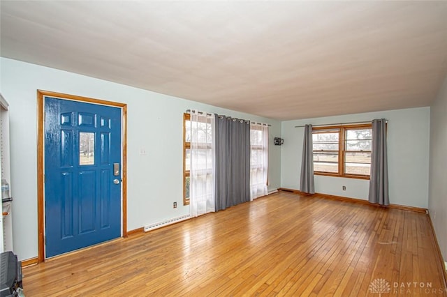 entryway featuring a healthy amount of sunlight, light wood-style flooring, a baseboard heating unit, and baseboards