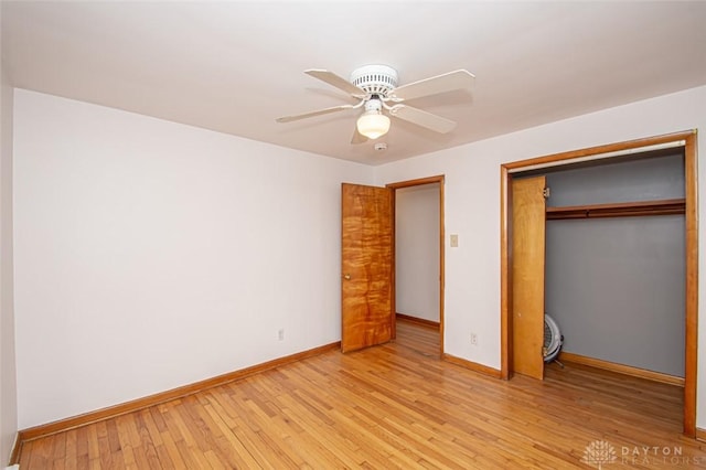 unfurnished bedroom with ceiling fan, a closet, light wood-style flooring, and baseboards