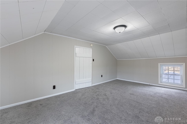 bonus room with carpet floors, baseboards, and vaulted ceiling