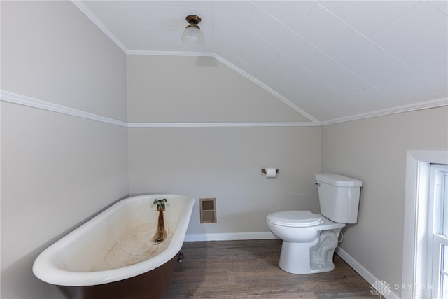 full bath featuring lofted ceiling, a soaking tub, toilet, wood finished floors, and baseboards