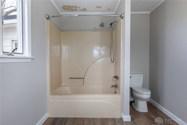 full bathroom with ornamental molding, shower / bath combination, toilet, and wood finished floors