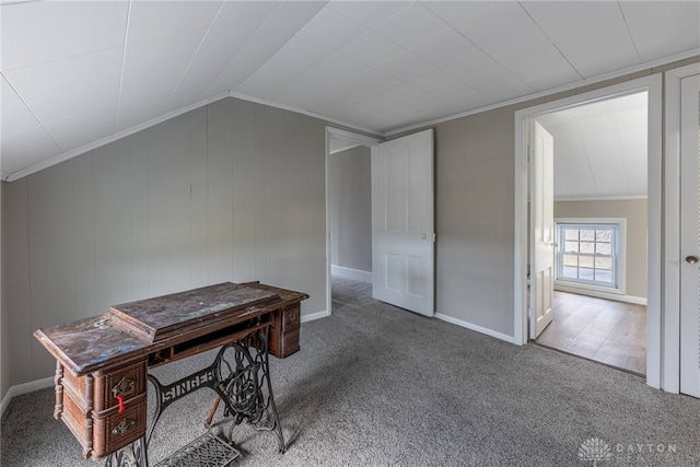 office area featuring carpet, baseboards, vaulted ceiling, and crown molding