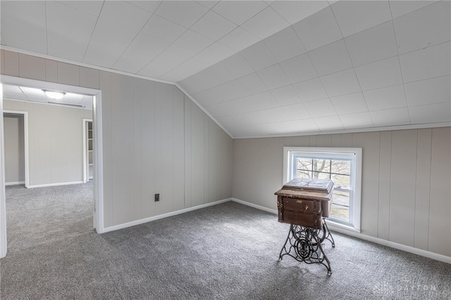 additional living space featuring carpet, lofted ceiling, and baseboards