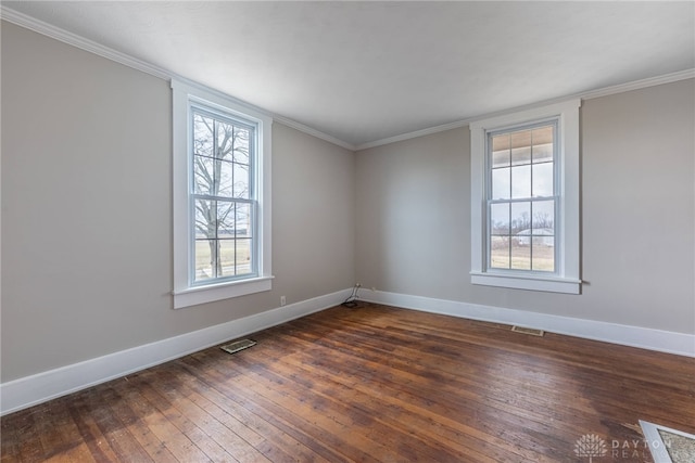 unfurnished room featuring ornamental molding, dark wood finished floors, and baseboards