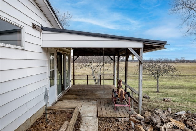 deck with a carport and a yard