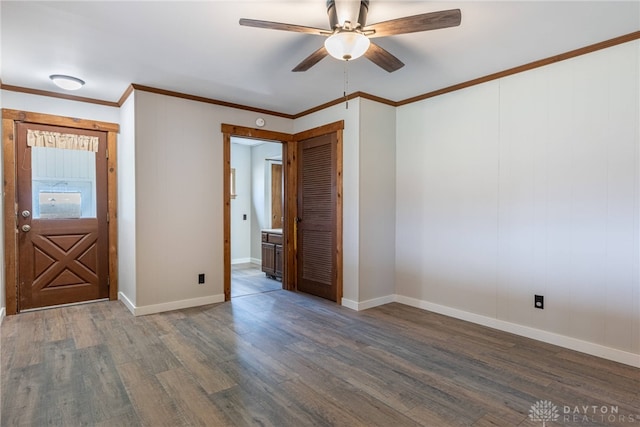 unfurnished room with baseboards, ornamental molding, ceiling fan, and wood finished floors