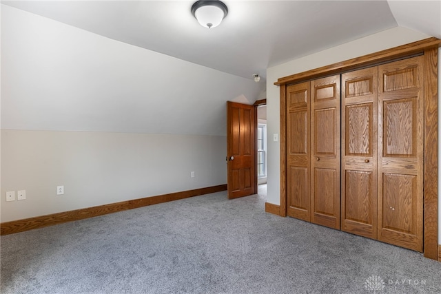 bonus room featuring vaulted ceiling, carpet flooring, and baseboards