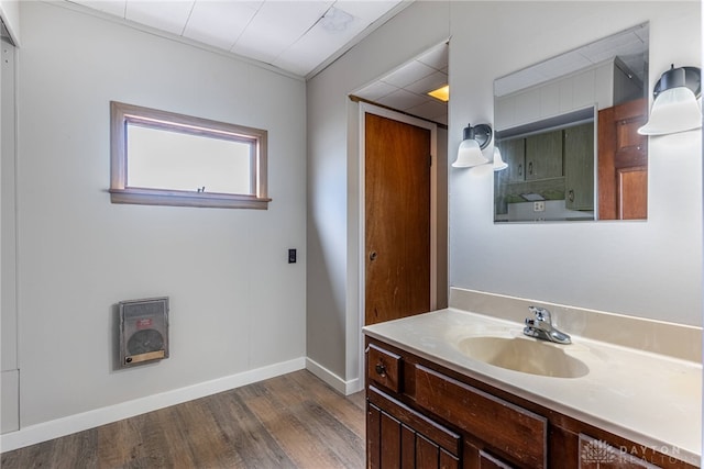 bathroom featuring baseboards, wood finished floors, and vanity