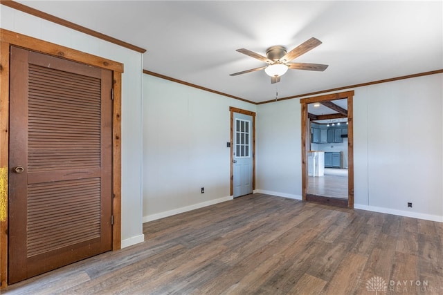 unfurnished room featuring crown molding, baseboards, ceiling fan, and wood finished floors