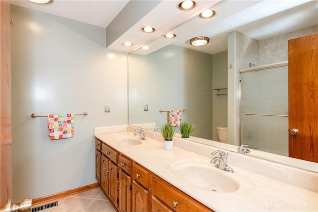 bathroom featuring tile patterned flooring, visible vents, a sink, and toilet