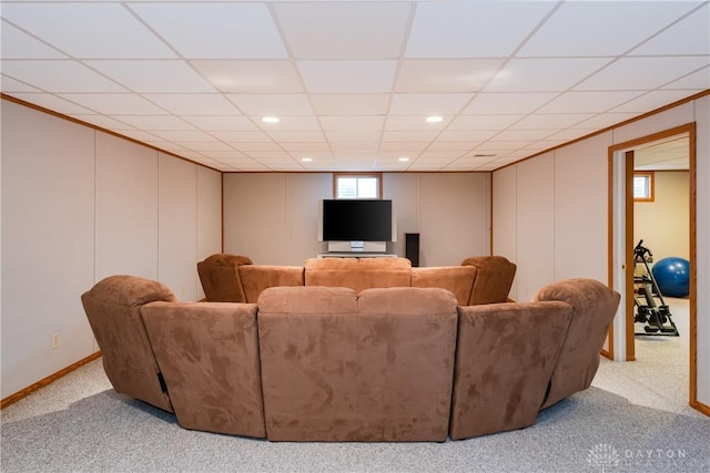 carpeted home theater room featuring baseboards, ornamental molding, a paneled ceiling, and recessed lighting