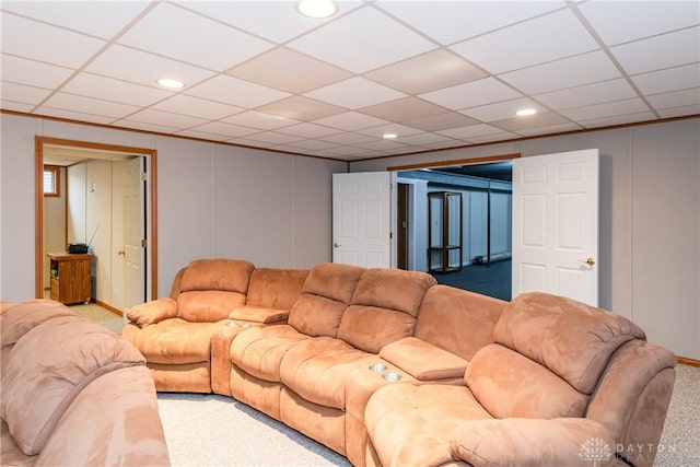 carpeted living area with a paneled ceiling, a decorative wall, and recessed lighting