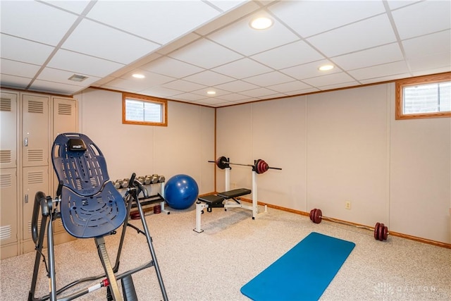 exercise room featuring carpet, a paneled ceiling, and recessed lighting