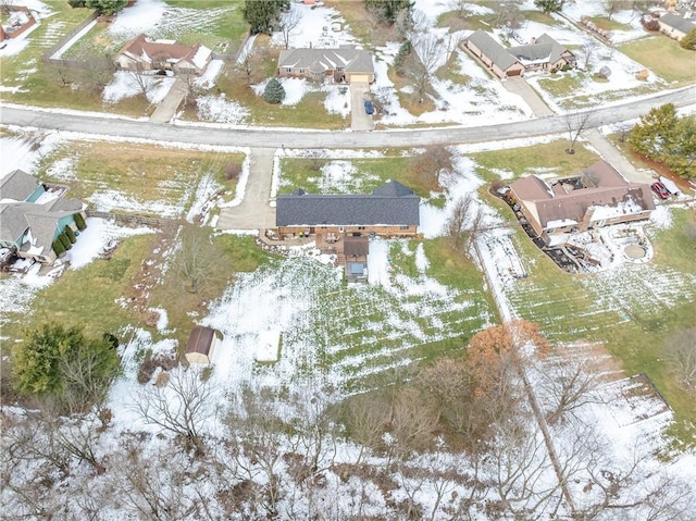 snowy aerial view with a residential view