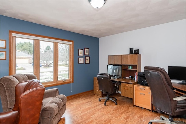 office with light wood-type flooring and baseboards