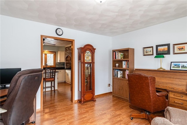 office featuring light wood-type flooring and baseboards