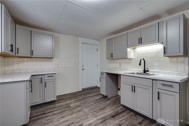 kitchen with a sink and gray cabinetry