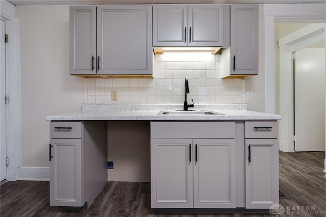 kitchen featuring gray cabinets and a sink