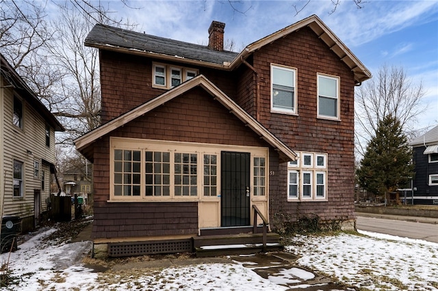 view of front of property featuring entry steps and a chimney