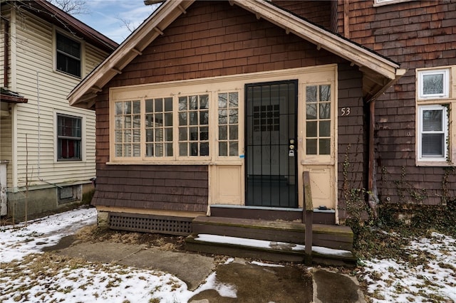 view of snow covered property entrance