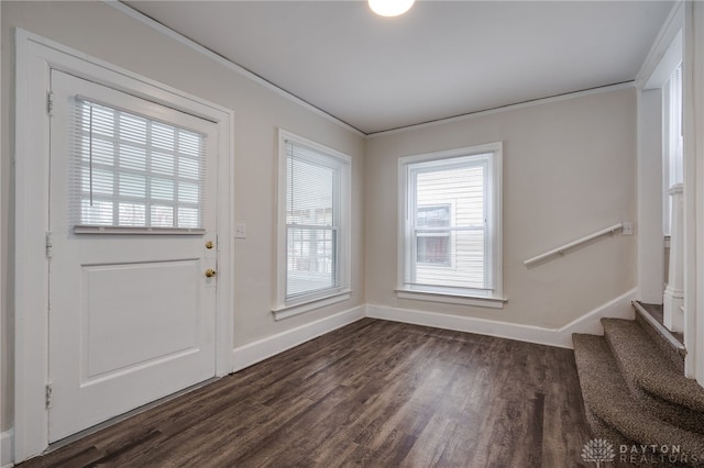 foyer entrance with stairs, baseboards, dark wood-style flooring, and ornamental molding