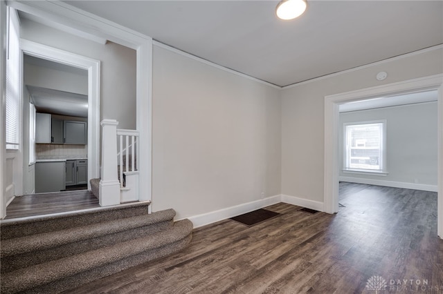 interior space with dark wood-style floors, baseboards, and stairway