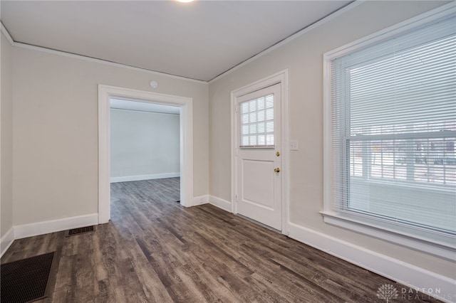 foyer featuring dark wood-style flooring, a healthy amount of sunlight, crown molding, and baseboards