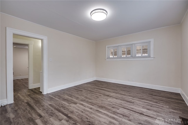 unfurnished room featuring dark wood-style floors and baseboards