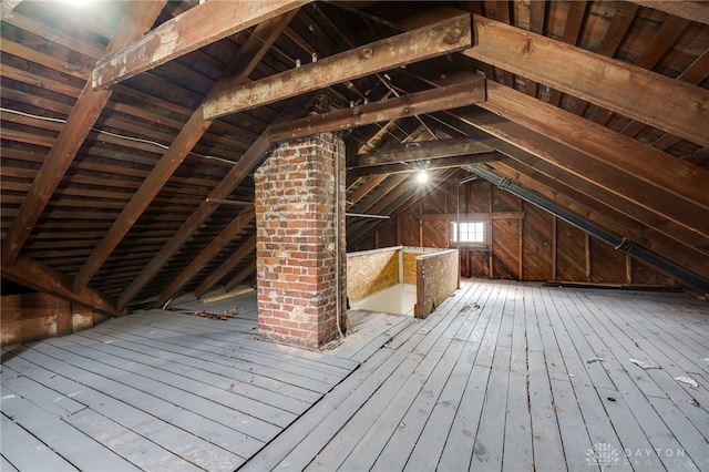 unfinished attic featuring an upstairs landing