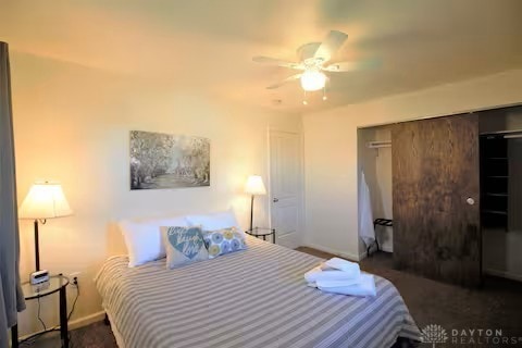 bedroom with a closet, ceiling fan, and baseboards