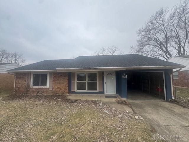 ranch-style house with a garage, concrete driveway, brick siding, and a shingled roof