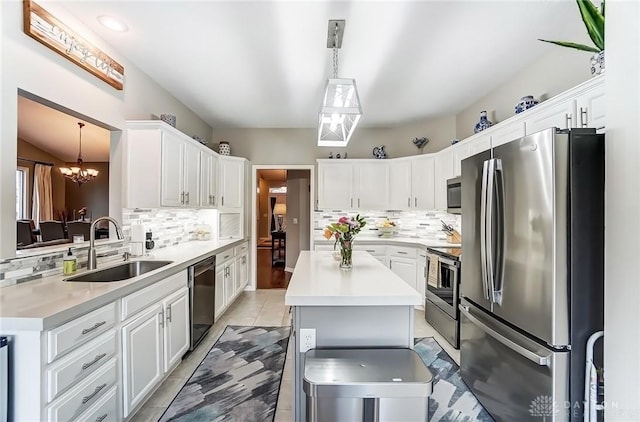 kitchen featuring white cabinetry, appliances with stainless steel finishes, light countertops, and a sink