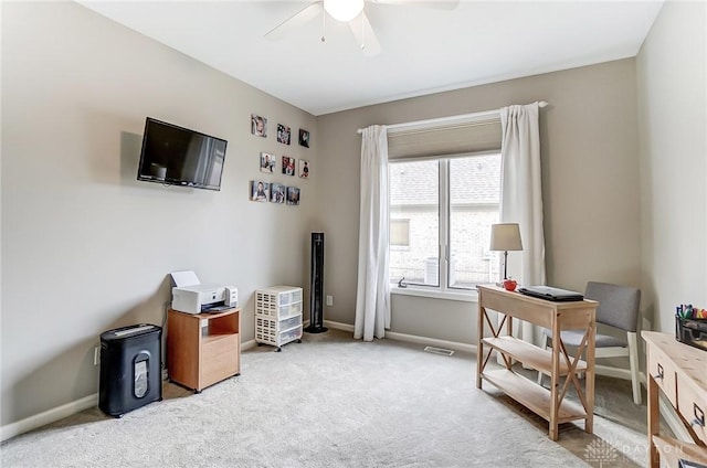 office with a ceiling fan, carpet flooring, visible vents, and baseboards