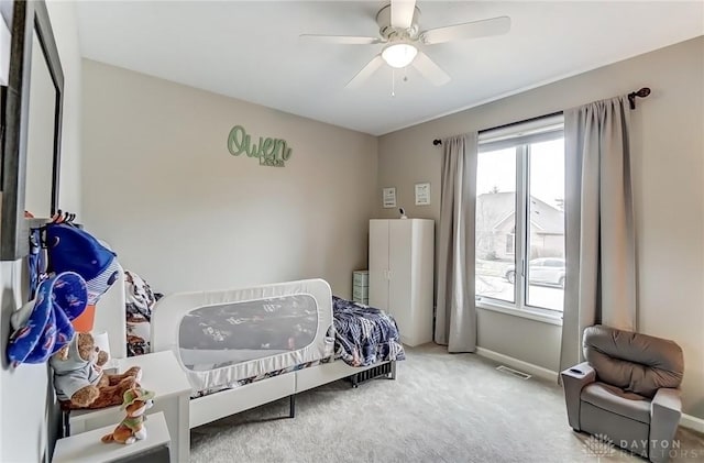 carpeted bedroom with visible vents, ceiling fan, and baseboards