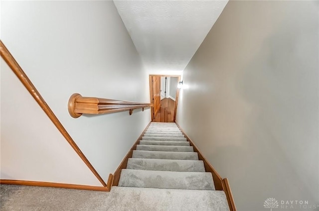 stairs with carpet flooring and baseboards