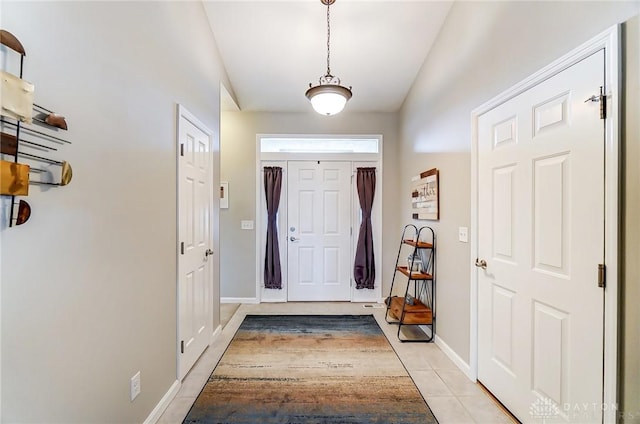 entryway featuring light tile patterned flooring and baseboards