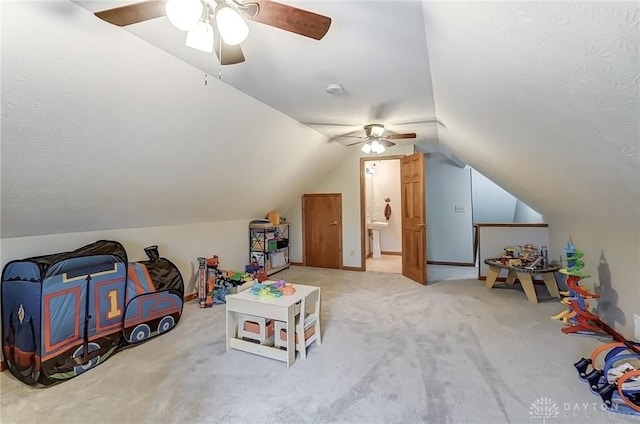 recreation room featuring carpet floors and vaulted ceiling