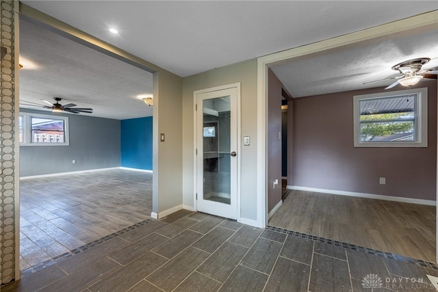 800 Mapleside Dr, Trotwood, OH 45426 - spare room featuring dark wood-type flooring, ceiling fan, a textured ceiling, and baseboards